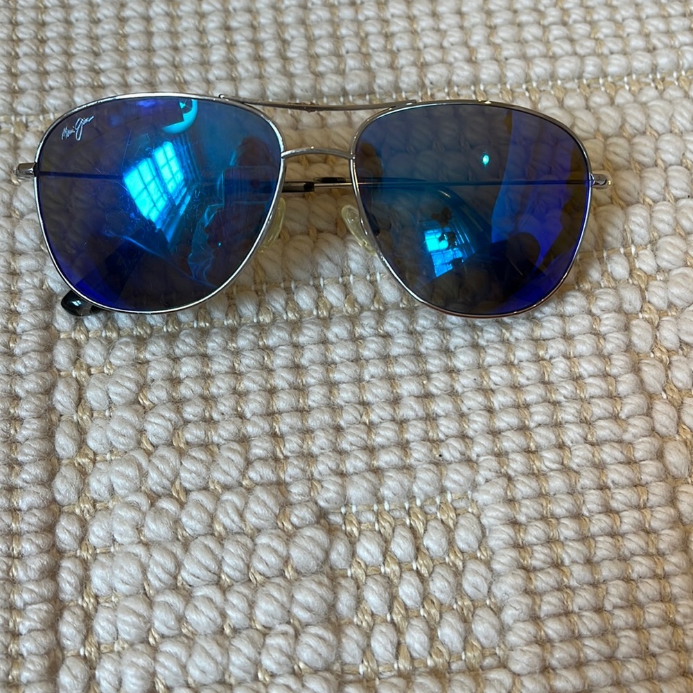 Maui Jim sunglasses with blue/green lenses and silver frame